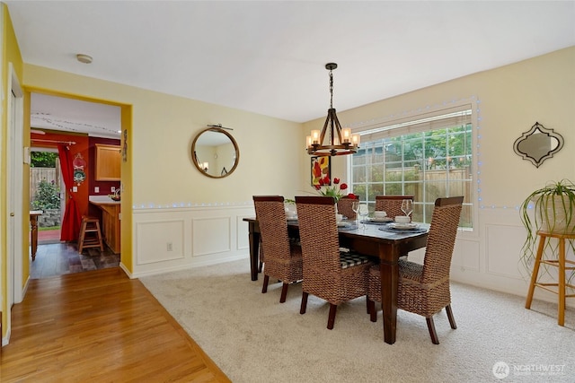 202 170th Pl SE, Bothell, WA 98012 - dining area featuring a decorative wall, a chandelier, plenty of natural light, light wood-type flooring, and wainscoting