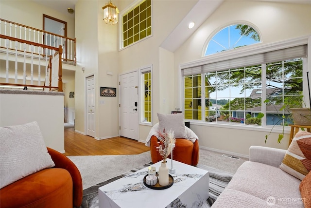 202 170th Pl SE, Bothell, WA 98012 - living room with high vaulted ceiling, baseboards, a chandelier, and wood finished floors