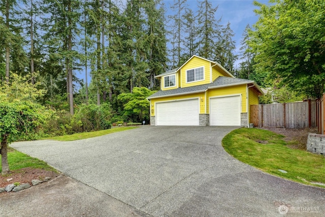 202 170th Pl SE, Bothell, WA 98012 - garage featuring asphalt driveway and fence