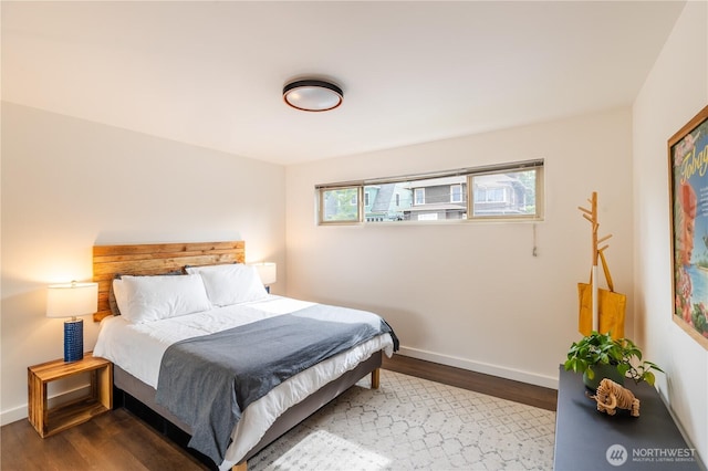 bedroom with wood finished floors and baseboards