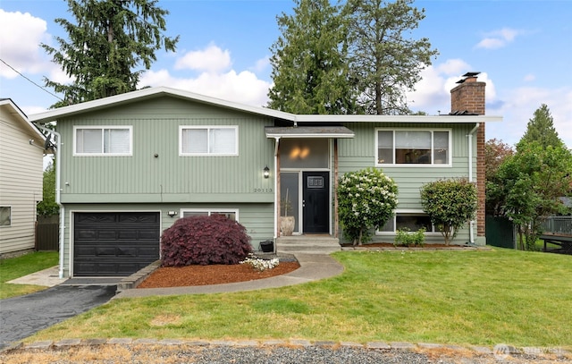 20113 4th Pl S, Des Moines, WA 98198 - bi-level home with a chimney, a garage, a front yard, and asphalt driveway
