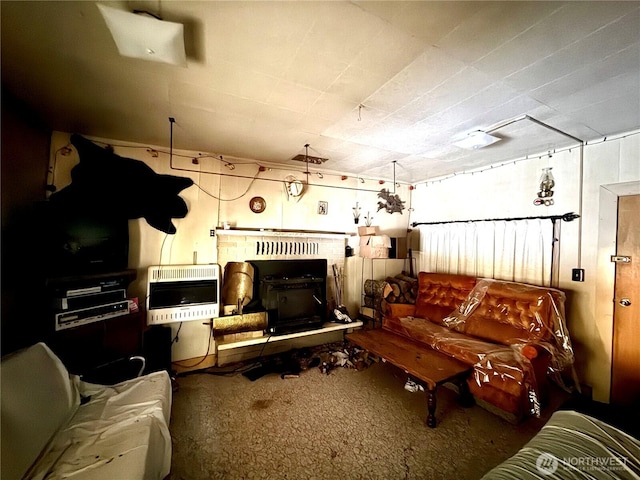 living room with heating unit and carpet floors