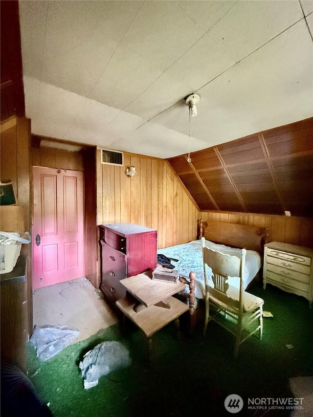 bedroom featuring wood walls and lofted ceiling