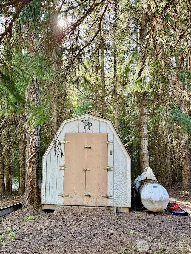 view of shed with a forest view