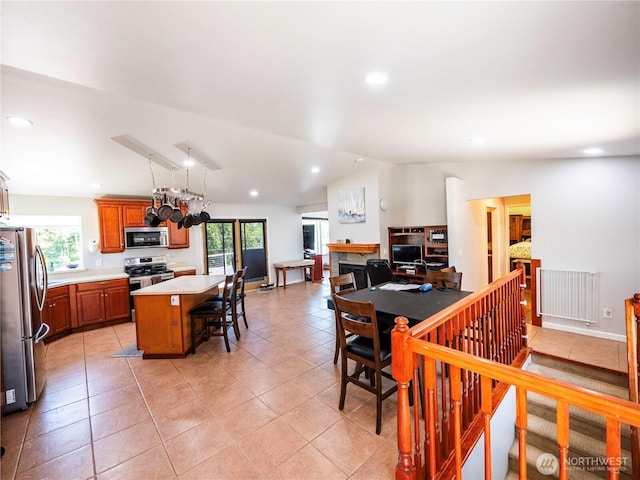 2207 Island Dr NW, Olympia, WA 98502 - dining room featuring lofted ceiling, plenty of natural light, recessed lighting, light tile patterned flooring, and a fireplace