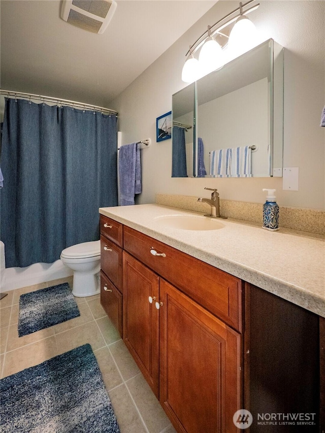 2207 Island Dr NW, Olympia, WA 98502 - full bath featuring toilet, vanity, and tile patterned flooring