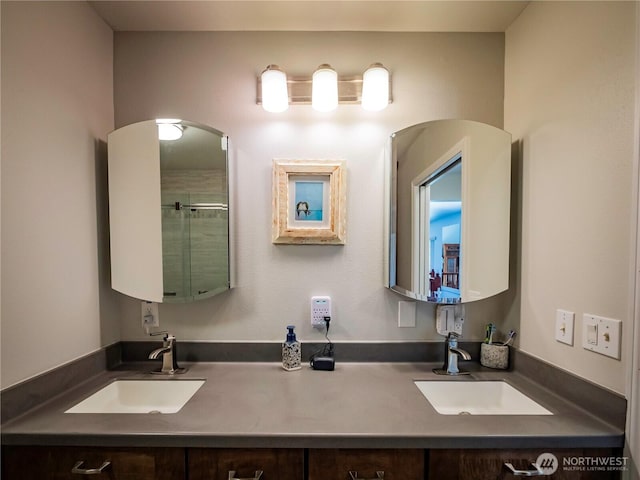 2207 Island Dr NW, Olympia, WA 98502 - bathroom with double vanity and a shower with shower door