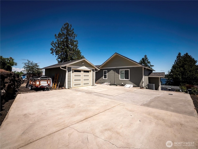 2207 Island Dr NW, Olympia, WA 98502 - view of front of house featuring an outbuilding, concrete driveway, and a garage
