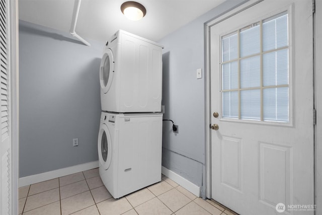 664 W Emerson St Unit A, Seattle, WA 98119 - clothes washing area with stacked washing machine and dryer, baseboards, and light tile patterned floors