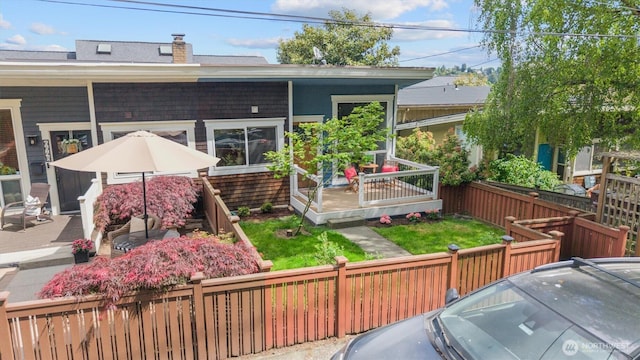 664 W Emerson St Unit A, Seattle, WA 98119 - rear view of property with a fenced backyard and a chimney