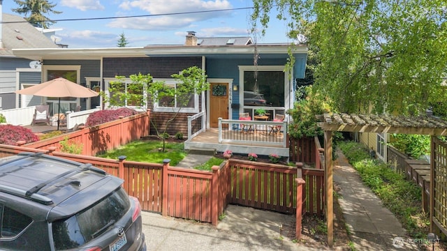 664 W Emerson St Unit A, Seattle, WA 98119 - back of house with covered porch and a chimney