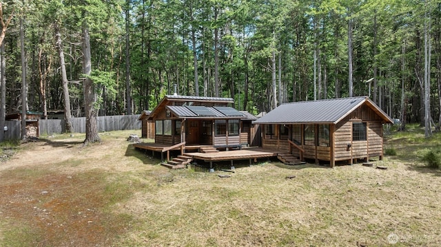 35 N Airport Way, Stuart Island, WA 98250 - rear view of property with metal roof, a forest view, and a wooden deck