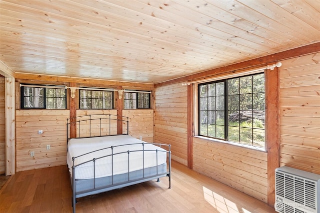 35 N Airport Way, Stuart Island, WA 98250 - bedroom featuring wooden ceiling, wood walls, wood-type flooring, and heating unit