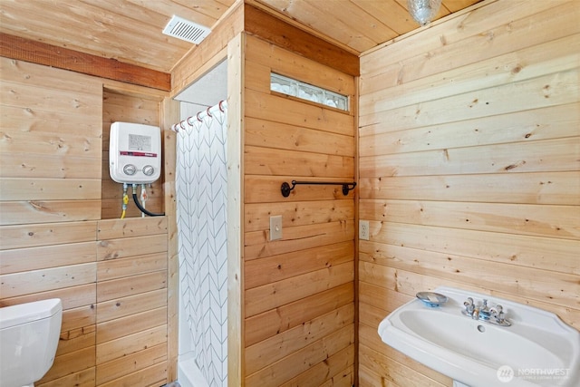35 N Airport Way, Stuart Island, WA 98250 - bathroom with wooden walls, a sink, toilet, a shower with shower curtain, and wooden ceiling