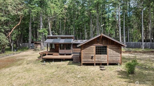 35 N Airport Way, Stuart Island, WA 98250 - back of property featuring a wooden deck, a view of trees, and metal roof