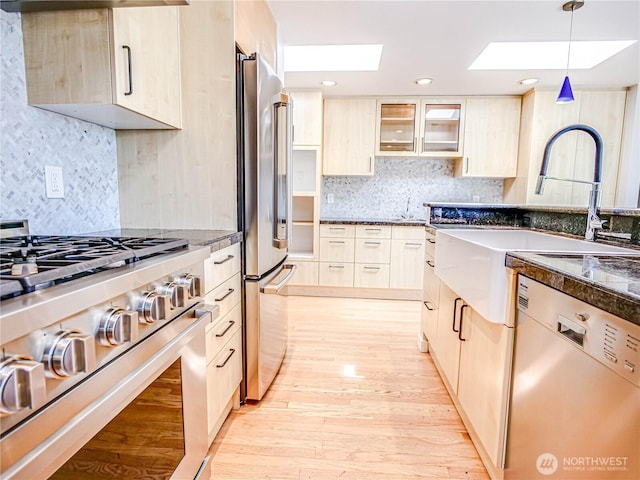 4441 53rd Ave SW, Seattle, WA 98116 - kitchen featuring premium appliances, light brown cabinetry, tasteful backsplash, a skylight, and recessed lighting