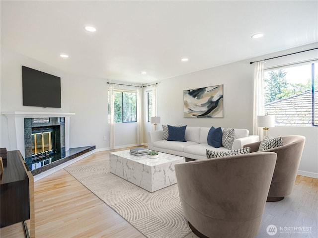4441 53rd Ave SW, Seattle, WA 98116 - living room featuring light wood-type flooring, recessed lighting, and a tiled fireplace