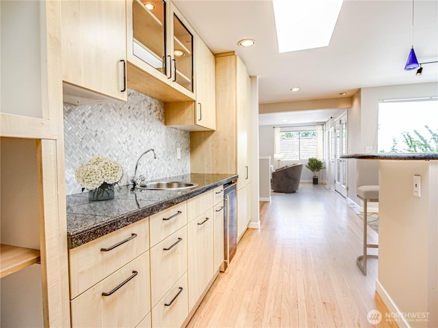 4441 53rd Ave SW, Seattle, WA 98116 - kitchen featuring tile counters, light brown cabinetry, light wood-style flooring, glass insert cabinets, and recessed lighting