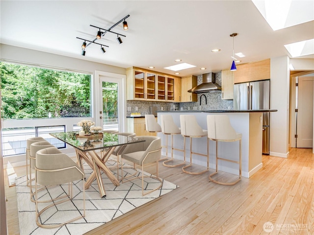 4441 53rd Ave SW, Seattle, WA 98116 - dining area with a skylight, light wood-type flooring, and recessed lighting