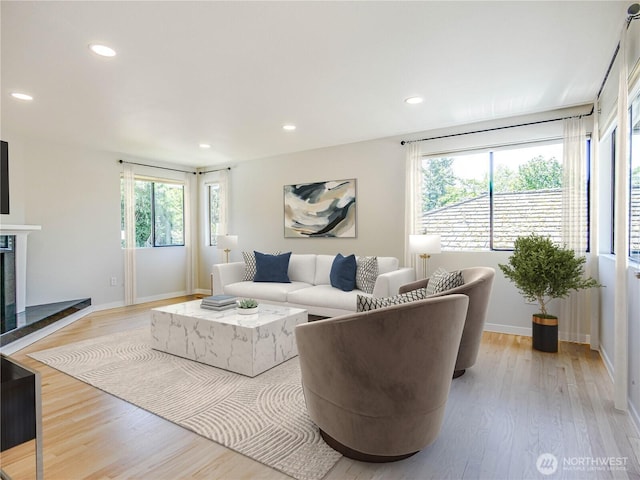 4441 53rd Ave SW, Seattle, WA 98116 - living area featuring light wood-type flooring, recessed lighting, and a glass covered fireplace