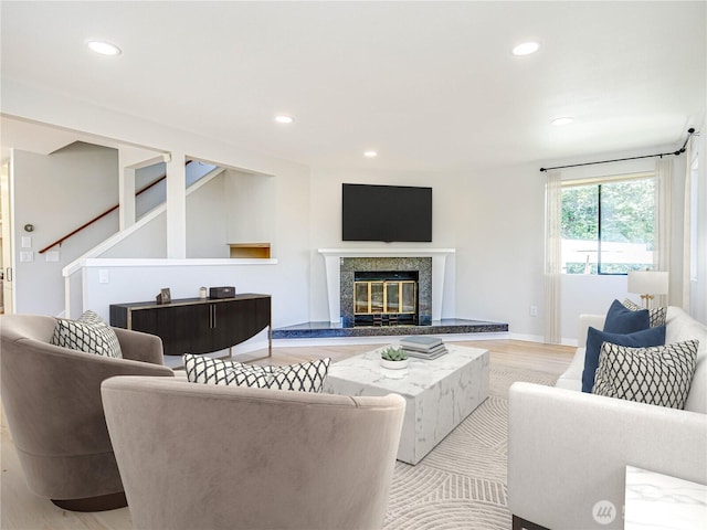 4441 53rd Ave SW, Seattle, WA 98116 - living area with recessed lighting, light wood-style floors, a fireplace, and stairs