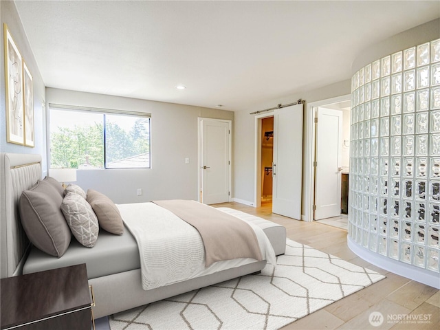 4441 53rd Ave SW, Seattle, WA 98116 - bedroom featuring light wood finished floors, recessed lighting, and a barn door