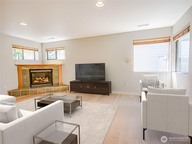 4441 53rd Ave SW, Seattle, WA 98116 - living area featuring light wood-type flooring, recessed lighting, and a tiled fireplace