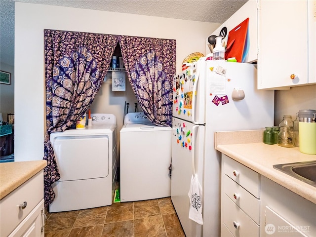 laundry room featuring washer and dryer and a sink