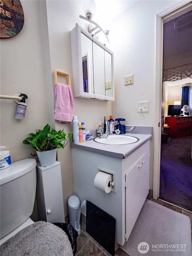 bathroom featuring toilet and vanity