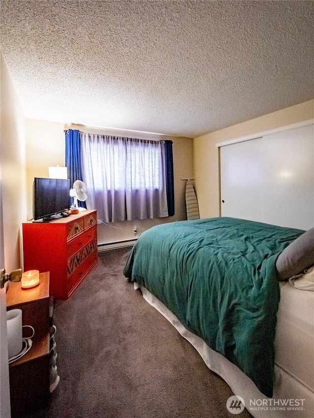 carpeted bedroom featuring a textured ceiling and a baseboard radiator