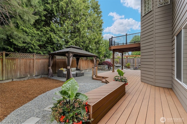 deck featuring an outdoor hangout area, a gazebo, a fenced backyard, and a patio