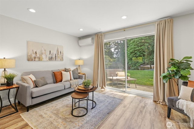 living room with a wall unit AC, wood finished floors, and recessed lighting