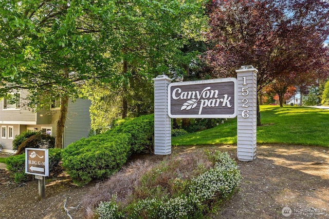 community sign featuring a lawn