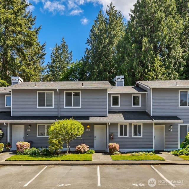 multi unit property with uncovered parking and a chimney