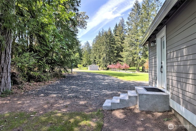 view of yard with a shed and an outbuilding