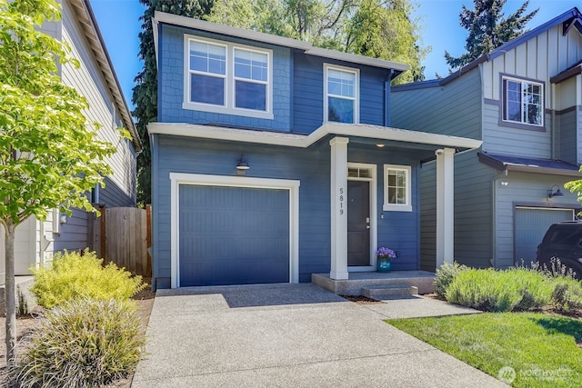 5819 NE 80th Ct, Vancouver, WA 98662 - view of front of house with a garage, concrete driveway, fence, covered porch, and board and batten siding