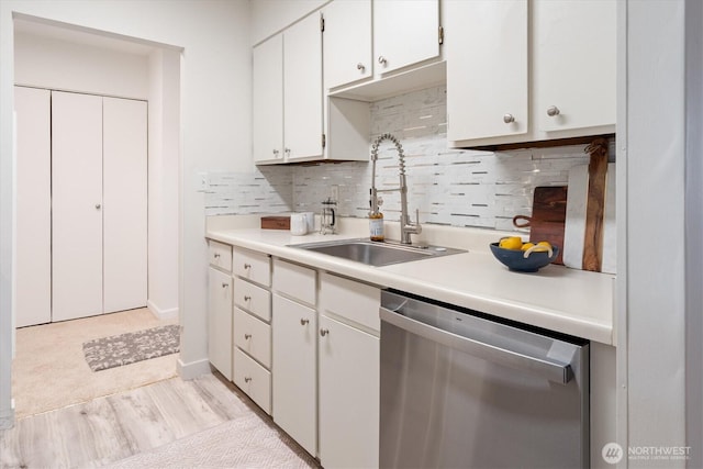 4540 8th Ave NE Unit 104, Seattle, WA 98105 - kitchen with stainless steel dishwasher, a sink, light wood finished floors, and light countertops