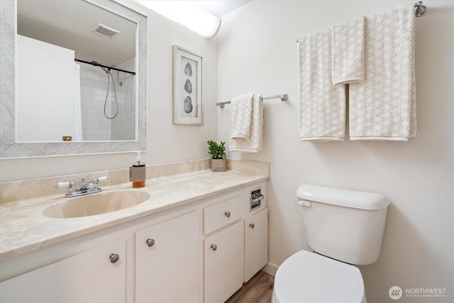4540 8th Ave NE Unit 104, Seattle, WA 98105 - bathroom with toilet, vanity, curtained shower, and wood finished floors