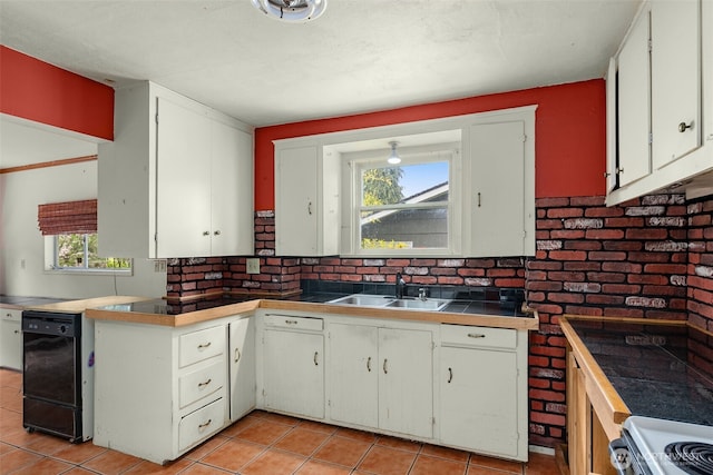 4319 SW Mills St, Seattle, WA 98136 - kitchen with a sink, light tile patterned floors, and white cabinetry