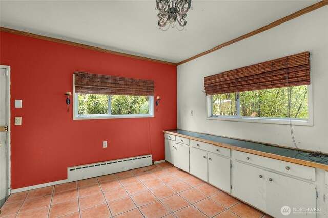 4319 SW Mills St, Seattle, WA 98136 - kitchen featuring baseboard heating, crown molding, white cabinets, and healthy amount of natural light