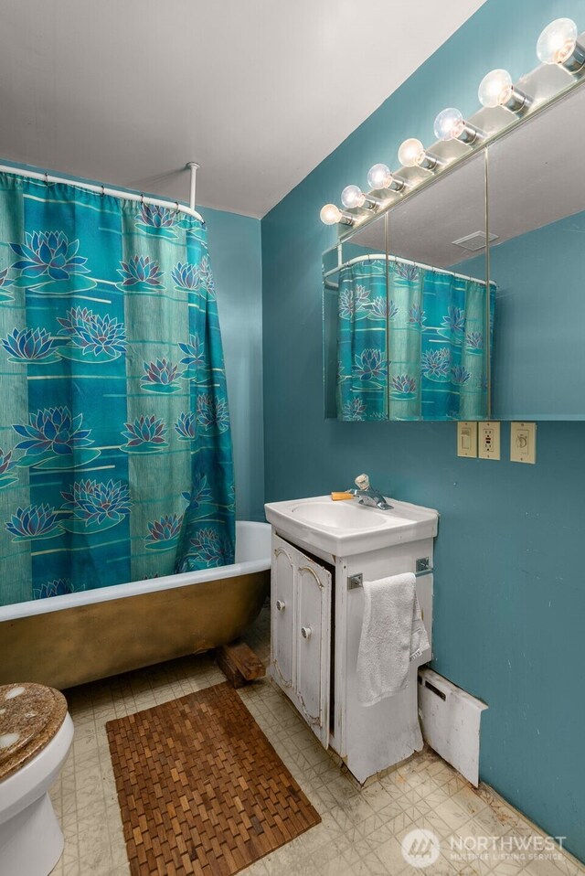 4319 SW Mills St, Seattle, WA 98136 - bathroom featuring tile patterned floors, shower / bath combination with curtain, toilet, vanity, and baseboard heating