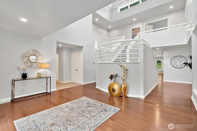 11950 NE 36th Pl, Bellevue, WA 98005 - foyer with wood finished floors, a high ceiling, baseboards, recessed lighting, and stairs