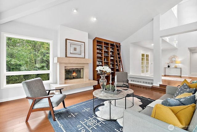 11950 NE 36th Pl, Bellevue, WA 98005 - living area featuring vaulted ceiling, wood finished floors, a fireplace, and baseboards