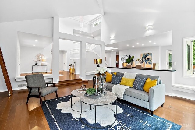 11950 NE 36th Pl, Bellevue, WA 98005 - living area featuring wood finished floors, stairway, a towering ceiling, baseboards, and recessed lighting