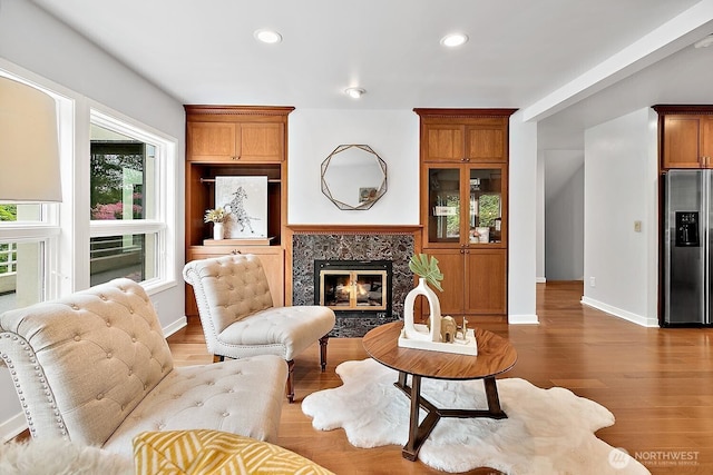 11950 NE 36th Pl, Bellevue, WA 98005 - living room featuring recessed lighting, wood finished floors, a high end fireplace, and baseboards