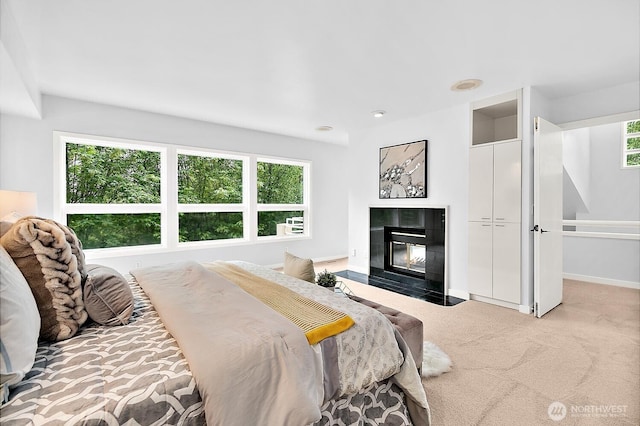 11950 NE 36th Pl, Bellevue, WA 98005 - carpeted bedroom with multiple windows, a tile fireplace, and baseboards