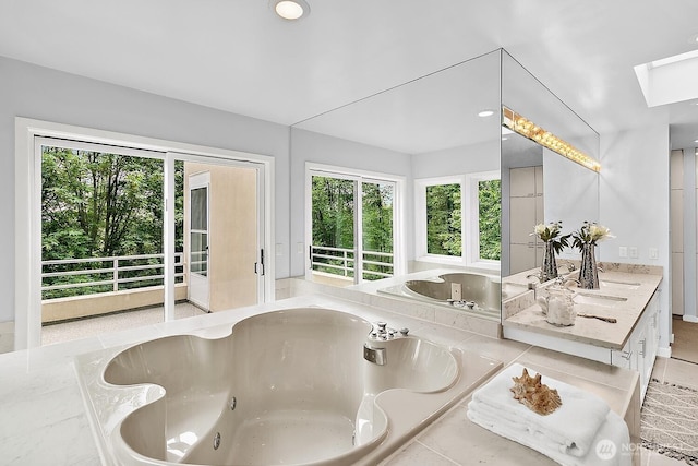 11950 NE 36th Pl, Bellevue, WA 98005 - bathroom with a jetted tub, a skylight, and vanity