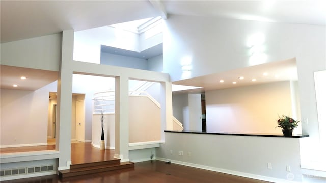11950 NE 36th Pl, Bellevue, WA 98005 - unfurnished living room with high vaulted ceiling, wood finished floors, beamed ceiling, recessed lighting, and stairs
