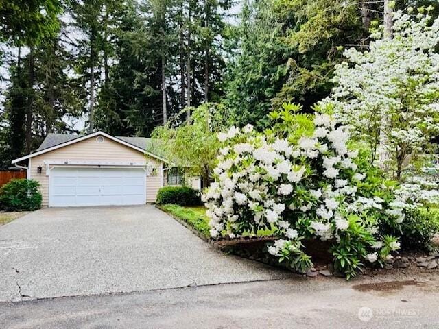 view of front of house with asphalt driveway and a garage
