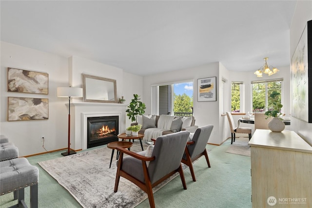 236 W Maberry Dr Unit 102, Lynden, WA 98264 - living area with a chandelier, a glass covered fireplace, baseboards, and light carpet